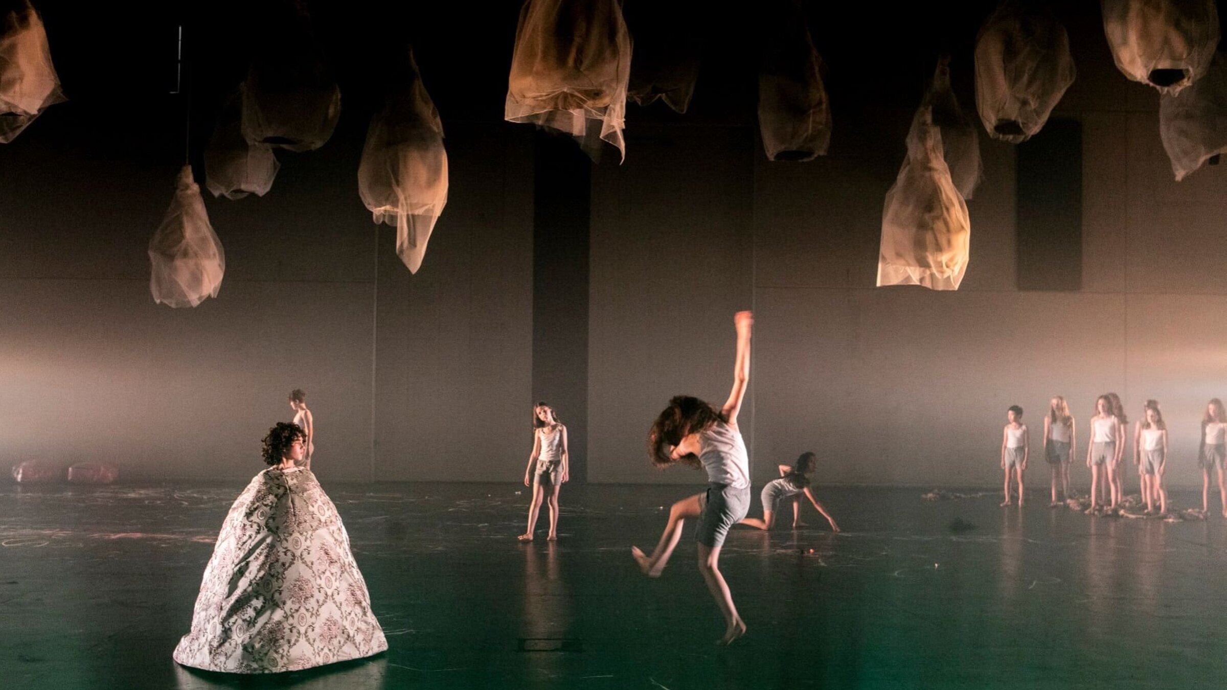 Force Majeure, Sydney Chamber Opera. Dancers in a fog-filled space beneath suspended lantern-like forms.